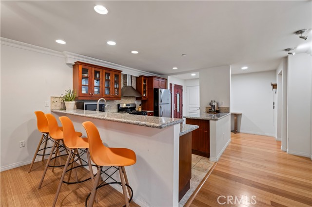 Bar top counter, recessed lighting and hardwood floors throughout