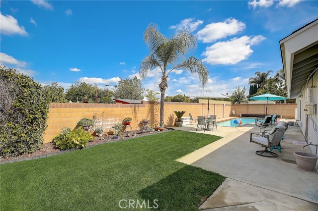 Rear yard with grass area and swimming pool.