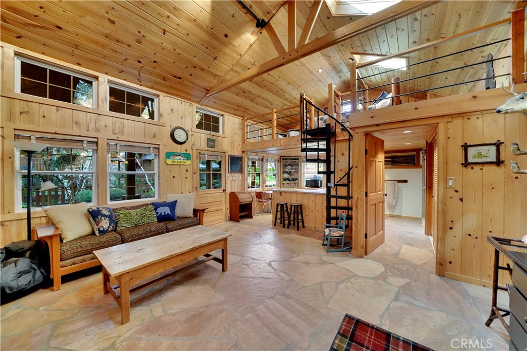 guest house with stone floors and wood paneling