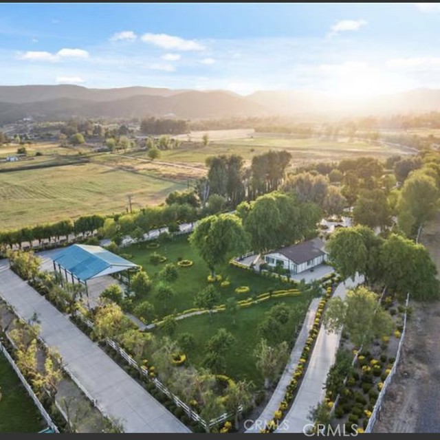 Looking for a CORPORATE RETREAT on the West Coast of California?  Here, we call it THE GEM OF THE VALLEY.  How about 8.36 ACRES of fully LANDSCAPED PARADISE? Including a LAKE full of Catfish with it's own WATER WELL @ 45 gallons per minute!  There is plenty of water for the 600 rose bushes, mature trees, and amazing collection of friendly pets; 200 Peacocks, 25-30 Turkeys, 40-50 Chickens, and Emu's, who add beauty and magnificence to the enjoyment of this uniquely created OASIS. This parcel has so many amenities, the list goes on and on.  There are tons of LED LIGHTS to make the night-life seem like you are living at a RESORT everyday.  Facing westerly, there are VIEWS of rolling hills from the Santa Ana Mountain range foothills. The Temecula/Murrieta Valley is surrounded by snow caps in the winter, which are breathtaking. This meticulously manicured, beautiful, peaceful and amazing property has it ALL and more!  A perfect PLACE of solace, creativity, imagination, and the SKY is the limit!
Located in the HEART of the CITY of MURRIETA in the County of Riverside which is the 4th largest County in CA and the SoCal Inland Empire. It is minutes from the TEMECULA WINE COUNTRY (#10 in the WORLD for it's WINE), PECHANGA CASINO (#1 Casino in the NATION) and only 1 1/2 hours from Los Angeles, San Diego, Big Bear, Palm Springs and BEACHES of the Pacific Coast.  There are TWO completely renovated HOMES on the property, including a 2,000SF LARGE Barn/Event BUILDING (garage, storage, meetings, banquets, parties, etc.) and STILL ROOM to build your DREAM Life!  BUT WAIT....this parcel also has a multi-faceted ZONING designation and LAND-USE OPPORTUNITIES galore within the GIA-Zoning District (GENERAL INDUSTRIAL-A).  The VALUE of this PROPERTY is PRICELESS with POTENTIAL for GREAT CREATIVE OPPORTUNITIES for an INCOME PRODUCING Buyer. DUE DILIGENCE suggested with local city agency, per City Zoning Standards.