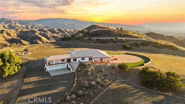 Nestled on a sprawling 10-acre plateau above the scenic mountains of Agua Dulce, this one-of-a-kind property offers the ultimate retreat from the hustle and bustle of the city. With breathtaking 360-degree views of the surrounding mountains and valleys, this stunning estate is a true oasis of tranquility and natural beauty.  Built in 1997, and the interior updated in 2022, this custom home boasts over 3,800 square feet of living space, with 4 bedrooms, 3 bathrooms, and a 3-car garage. The grand foyer welcomes you, leading to the spacious living room 22-foot high ceiling, a grand fireplace, and windows that capture the views. The gourmet kitchen features top-of-the-line appliances, granite countertops, and a spacious center island, perfect for preparing gourmet meals and hosting family gatherings. The formal dining room is ideal for dinner parties, with windows that open to gorgeous mountain views. The luxurious master suite offers a peaceful retreat, with a sitting area, and direct access to the outdoor patios with stunning views. The master bathroom features a spa tub, dual sinks, and a walk-in shower. Three additional bedrooms offer ample space for family and guests.  One bedroom is connected to another large room that could be used as a office, additional sleeping area, closet or gym, with it's own en-suite bathroom!  The outdoor spaces are truly breathtaking, with a giant patio, and expansive lawn area, market lights, perfect for outdoor entertaining or simply enjoying the beauty of nature. 

The property (known as “Diamond View Summit”) is tailor-made for large events, and has hosted over a hundred weddings, quinceanaras, and private parties; in addition to location filming for CSI, NCIS, Snowfall, and many other shows. 

This 10-acre site is most flat, and can easily accommodate massive expansion plans, parking for hundreds of vehicles, multiple ADUs, barns and other storage and work areas, equestrian facilities, other sports (tennis, pool, golf, etc.), or just continue to enjoy the open space that surrounds you!  Located just 30 minutes from the city, this estate is the perfect combination of privacy and convenience, offering easy access to the best that Los Angeles has to offer, all with priceless sunsets, and closer to heaven and the stars!  Don't miss this rare opportunity to own this “top of the world” estate!

This property is also available for rent for $10,000 per month.