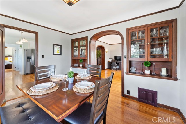 Dining room with built-in cabinets and coved ceilings.