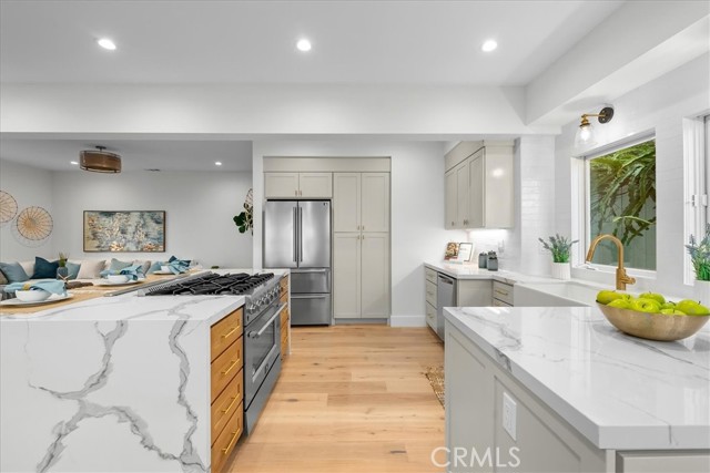 Stone waterfall kitchen island with all new appliances and cabinetry.