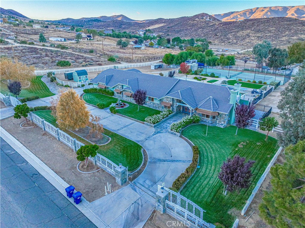 2.2 acre gated ranch home with fenced and lit tennis court! Massive pool! Custom pavers! 4000 sf single story home with incredible floorplan - currently 4 bedrooms with a HUGE game room. The game room could be easily converted to separate living area with its own kitchen and bath! Updated kitchen and bath! Updated water heater/AC units/heaters/ducting. $100,000 in pavers! Updated gate motors! Updated pool equipment and plumbing! If you want the dream horse property or your own personal professional grade tennis court - THIS IS A MUST SEE!!