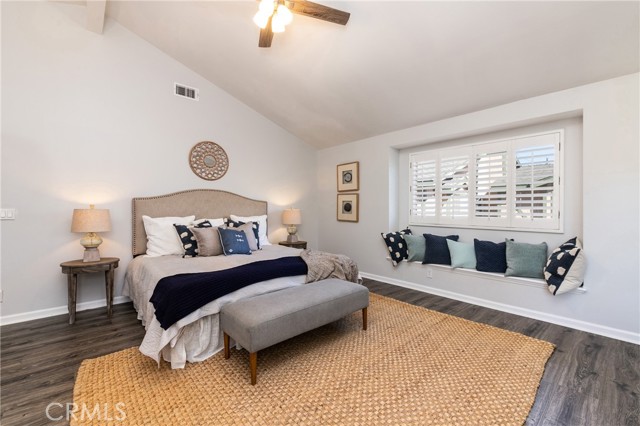 The bright main bedroom features a window seat