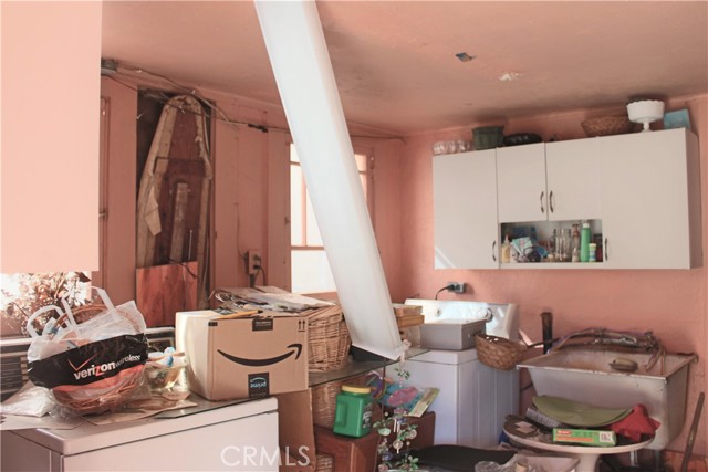 Laundry Room.  Florescent light is hanging down.