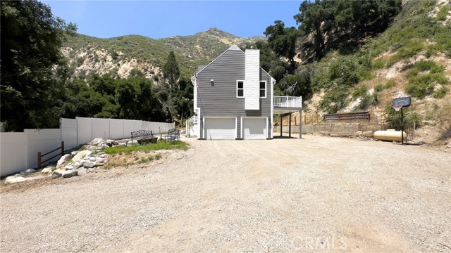 A VIEW OF THE TWO CAR ATTACHED GARAGE, PATIO CARPORT AREA