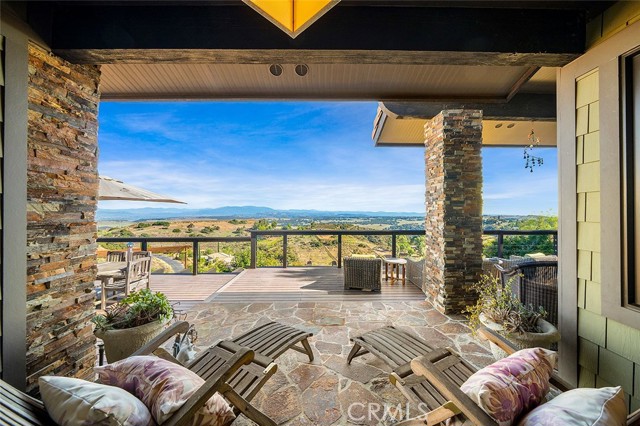 CROWN JEWEL OF LA CRESTA! Words and pictures do not begin to demonstrate the fine detail & quality construction of this custom Craftsman Masterpiece with No HOA on the Santa Rosa Plateau. From the moment you enter the private gate, be swept away by nature, whimsy, privacy, and the jaw-dropping unobstructed views over 8000+ acres of Nature Reserve to the San Diego skyline & Southern California coast. The quality of this home is a rarity, taking years to construct, with artisan appointments inside & out. EVERY piece of hardware, fixture, cabinet, stained glass, door, tile, window, floor, stone, appliance…was meticulously curated to complement the authentic Craftsman style & exude a memorable moody ambiance. Stroll the grounds via enchanting pathways past the infinity pool, hidden spa, firepits, natural-stone benches, outdoor showers, fruit trees, dog playground, adult swing set, to the prolific garden with potting cottage, chicken coop & 2 guest bungalows with private decks. Inside, when you can take your eyes off the views from every window, you will notice detail after detail, including the professionally designed kitchen with its luxe appliances, including the La Cornue range & copper repousse-detailed hood. The kitchen opens to a great room with beamed ceilings, and beyond are the library with built-in white oak cabinetry, dining room with private deck, and cozy sunroom – all with epic sit-down views. The primary suite is a sanctuary with forever views and an elegant bathroom with heated stone floors and hammered copper & polished nickel soaking tub. The fun doesn’t stop, as downstairs is a massive game & media room w/walk-in bar. The room opens to an entertainers’ dream pool deck, koi pond, waterfalls, ensuite pool house/gym, alfresco dining room, and an outdoor kitchen with refrigerator, icemaker, dishwasher, 2 sinks, and a show-stopping copper-clad pizza oven. All of this magical wonderland is accentuated by the priceless backdrop of the Santa Rosa Plateau, Pacific Ocean & city lights views. It cannot be duplicated.***Santa Rosa Plateau: 5-acre minimum parcels, star-filled skies & peace – just minutes to schools, restaurants, hospitals, grocery stores, 15 Fwy & the famous Temecula Wine Country. Enjoy community activities & miles of trails via the private trail system & 1000s of acres of Ecological Reserve…All less than 1.5 hours from LA, SD, OC, Palm Springs & Big Bear. Discover the country, yet convenient, lifestyle of La Cresta & Tenaja!