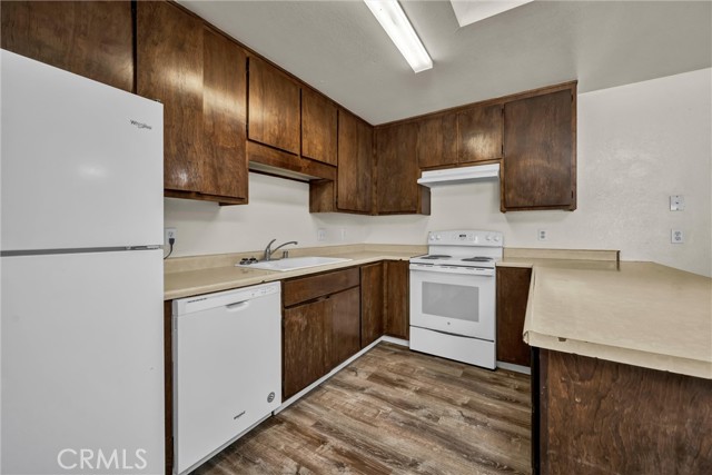 Kitchen has breakfast bar in the nook.