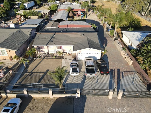 9883 Carob Avenue Fontana, California Residential property lot size 24,600 sqft. 4 bedroom, 2 bath house built 1960. Large metal entry gates 17' and 15' wide front access. Granite flooring throughout the house, open kitchen. Garage drywalled and wood flooring. Bedroom 2,3 wood flooring. bedroom 4 tile flooring and has secondary access to backyard. Backyard all cement slabs and pavers, includes childs play area, 2 covered carports 18'x61' and 18'x51' with enclosed office. storage shed 10'x18'. Newly planted citrus trees. Large queen palms throughout backyard. Outside restroom for guests.