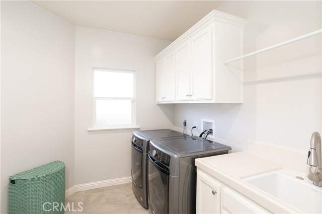 A separate laundry room is located across from the entry and next to the kitchen.