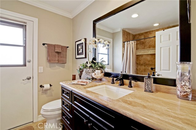 Guest bath with newer vanity, recessed lighting and crown moldings. The tub area was extended to accommodate the large jetted tub