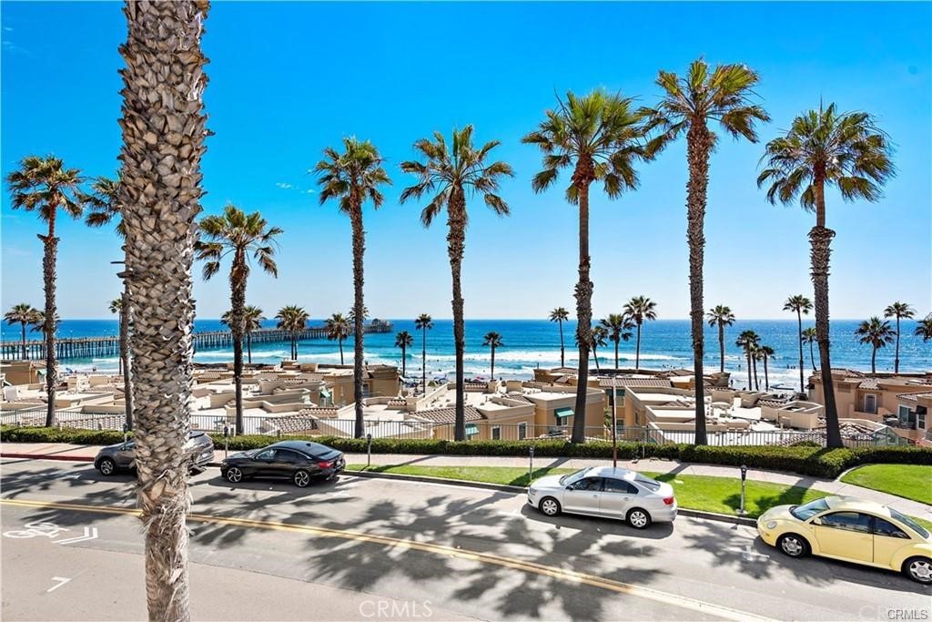 Enjoy resort style living steps from the beach in this beautiful 2BR, 2BA condo with Spectacular Ocean and Pier views in the very desirable San Miguel lV gated community in Oceanside. Amazing open floor plan, sunny & bright living room w/cozy fireplace, stunning ocean views from large private balcony, LR & DR. Upgraded kitchen with custom cabinetry, quartz counters, stainless steel appliances and breakfast bar. New quality carpet throughout the unit. Spacious bedrooms, upgraded baths w/ quartz counters.  Unit includes stacked Washer/Dryer and 2 assigned parking spaces.
San Miguel lV is located between Oceanside Harbor and Oceanside Pier, with resort style amenities: including pool and spa overlooking the beach and the Pier. Great location, walk to the beach, harbor, pier, downtown, movies, restaurants & commuter rail.