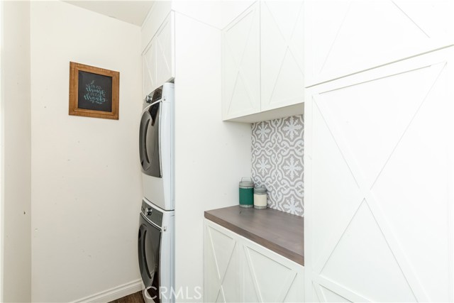 Upgraded Laundry room with custom cabinetry and vinyl flooring