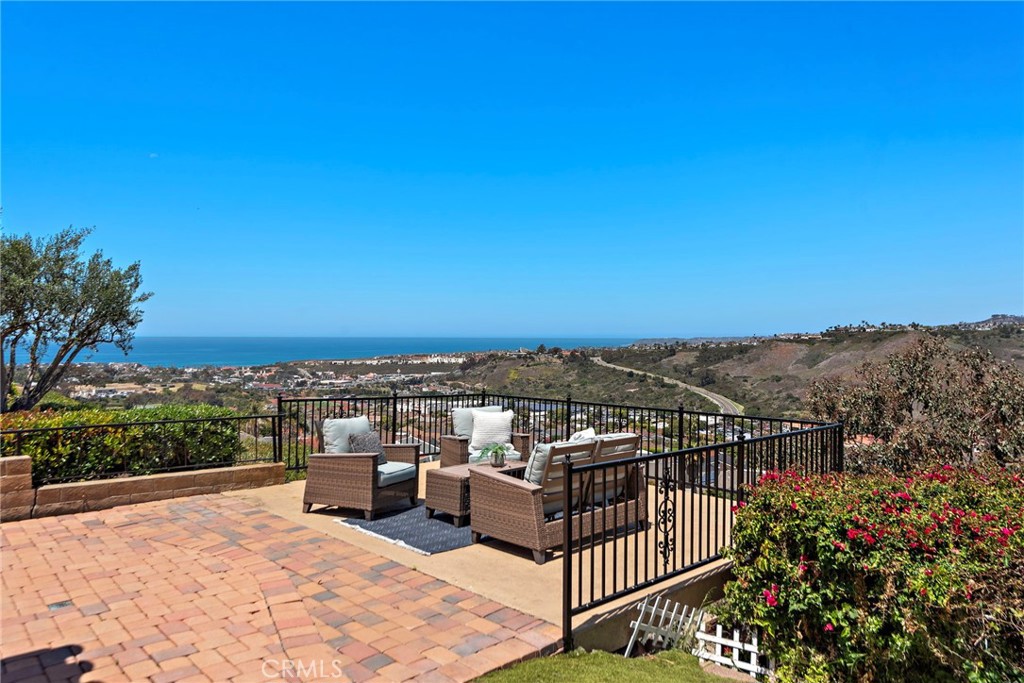 It's time to envision your new life in San Clemente while surrounded by PANORAMIC OCEAN VIEWS & GENTLE OCEAN BREEZES!!!! Bursting with captivating character, this Spanish Architectural-style San Clemente residence is one you will be proud to call your own!  Enviably set on a peaceful, single-loaded cul-de-sac PLUS the parcel is a highly-coveted STREET TO STREET LOT!!!   Impeccable landscaping dotted with low-maintenance foliage and vivid blooms border the eye-appealing brick inlay driveway enhancing its captivating curb appeal.  Past the gated courtyard, enter a vibrant, open-concept interior where vaulted, beamed ceilings soar and you are met with a wall of expansive windows & glass sliders showcasing the OCEAN VIEWS & PANORAMIC VISTAS!!  The main floor offers a very versatile floorplan allowing you to gather in the living room at the front of the home which features a gas burning fireplace, custom built-ins, and gorgeous wall molding.  Guests may choose to congregate at the back of the home which is highlighted by a GREAT ROOM that includes the cozy family room, gourmet kitchen with stainless appliances, center island with pendant lighting, and a plethora of cabinetry - formal dining area and a quaint breakfast nook.  Two generous sized bedrooms are also located on the main level -- one offers ensuite amenities with a remodeled bath with a walk-in shower which could also serve as a MAIN FLOOR PRIMARY.  The remodeled hall bath with tub & shower services the additional bedroom.  Awaken refreshed and ready to take on the day in your primary suite showcasing vaulted, beamed ceilings, raised hearth fireplace with custom mantle, large walk-in closet, and spa-like remodeled bath with dual vanities, and walk-in shower.   Morning coffee on your private balcony will be a fantastic way to start your day!   Ardent entertainers will love the generous layout for hosting festive gatherings, including the sun-kissed patio with an extended sitting area to appreciate the BREATHTAKING VIEWS!!!!  The secluded backyard is a large venue highlighted by a covered dining area which will create endless memories.  Other notables include an inside laundry room and an attached 2-car garage with additional storage. In a nutshell, this property is the full package with a fantastic location within the boutique Broadmoor neighborhood.   It's time to grab your chance to live the life most people dream of!!!