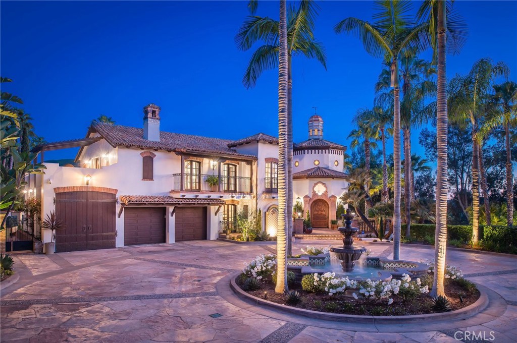 This majestic Spanish Colonial Hacienda-style estate, "VILLA VISTA," perched in the hills of San Juan Capistrano, captures the essence of luxury, privacy and serenity and presents a masterpiece in design and architectural detail on nearly 1.5 acres. Elegant and grand, this spectacular home is designed for entertaining a crowd or relaxing in this secluded sanctuary with privacy, views of the hills, golf course and twinkling lights of the city. Enter this hidden showplace through gates which lead you to an expansive curved driveway and to a circular motor court with a large center fountain while surrounded by over 100 palm trees. The timeless architectural elements set the stage for this romantic and classic VILLA recently remodeled with a modern and contemporary flair. A hand-carved arched entry door greets you and the dazzling double rotunda entry brings you to a dramatic living room with arched windows, massive stone fireplace, mahogany floors and soaring ceilings. The Living Room opens to a view patio complete with Cantera stone balustrades while the nearby formal Dining Room spotlights a coffered brick ceiling and beveled glass French doors open to a cozy patio. Complete with a 72" commercial style refrigerator and 60" Thermador gas range, this spacious new Chef's Kitchen includes a wine bar and Breakfast area with French Doors to the "Kitchen Garden." In addition, the main level includes an all new Powder Room plus 3 luxurious ensuite guest Bedroom suites each with balconies. The sweeping staircase with new iron railings leads you to the Library/office and to the spacious Primary Suite with a cozy Sitting Room, 4 balconies and an all-new lavish Bath. Highlighting the fun and festive way of living, the downstairs boast the ultimate for gracious entertaining featuring a large Family Room with sit-down bar, balcony and fireplace, Game Room, Hobby/Craft Room, Wine Tasting Room and Wine Cellar, all new Bath and large Laundry Room. French doors open to the massive sport's Pool and Spa and to the outdoor "Cantina" Kitchen with dual BBQ's, sink, and refrigerator...all with panoramic views, alfresco dining and a large grassy area. This spectacular estate property includes a total of 4 Bedrooms, 5.5 Baths, story book balconies, and a total of 5 car garage spaces with RV Garage. Enjoy the enchanting natural beauty and quiet elegance blended with the colorful charm of old and new offering resort-style living all year around in this hidden treasure, "VILLA VISTA."