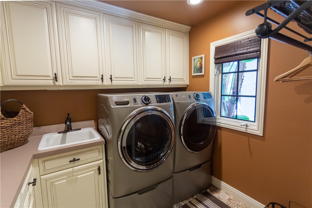 separate laundry room with sink and storage. Door has been removed but is available if you wish to put them back on.