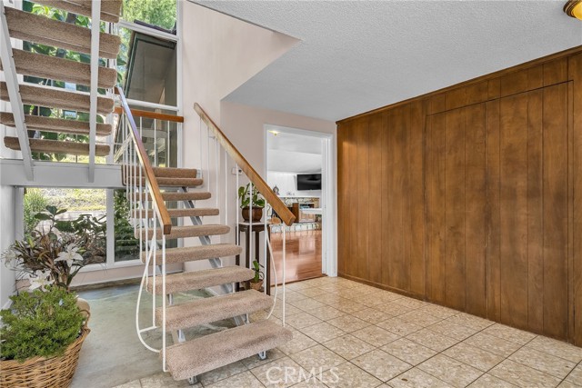 Large entry hall with wall of storage.