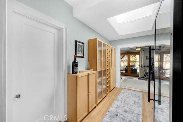 Breezeway to office with skylight and cabinets.