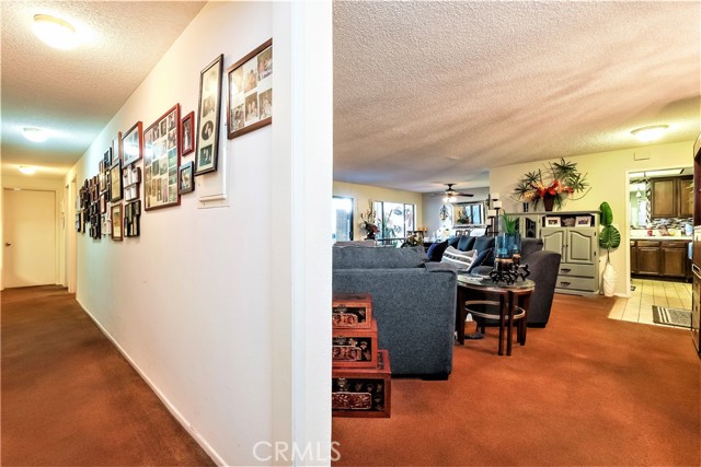 The Entire Length of the Hallway is lined with Storage Cabinets, a Credenza with Abundant Storage, Closets and a Laundry Area.