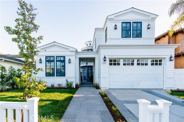 1545 Voorhees Avenue Manhattan Beach, California Perched on a hilltop, this brand new Nantucket style beach home has views of Downtown LA and the Santa Monica Mountains. Courtyard entry with detached "work from home" Casita with bathroom, perfect as an office, guest suite or yoga studio. The open floor plan flows back to the kitchen and family room with fireplace and custom built-ins. The kitchen has high-end Thermador appliances, including a 48” range, full-size side by side refrigerator and freezer, microwave drawer, large island, walk-in pantry, and breakfast nook. The butler’s pantry leads to the formal dining room that is a wine lover's dream... a temperature controlled wine wall that stunningly displays 800 bottles. From the family room, a wall of glass doors opens to a covered patio with fireplace and outdoor kitchen with DSC 48”grill and stainless steel DCS drawers. The backyard is also plumbed for a swimming pool. There's a mudroom area just off of the extra-deep 3 car garage. Upstairs houses the master suite with vaulted ceilings, fireplace, balcony, massive walk-in closet, and serene spa-like master bathroom with custom tile and stone design. There are three additional bedrooms and two bathrooms upstairs. This home balances luxury with utility, featuring hardwood floors, two air conditioning units, and the largest available residential elevator. Walking distance to award winning elementary, middle and high schools, this home perfectly complements the wonderful lifestyle of MB.