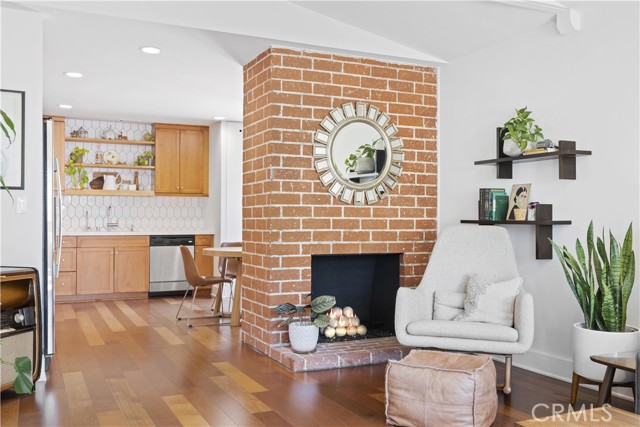 Warm fireplace divides the space between open concept living.