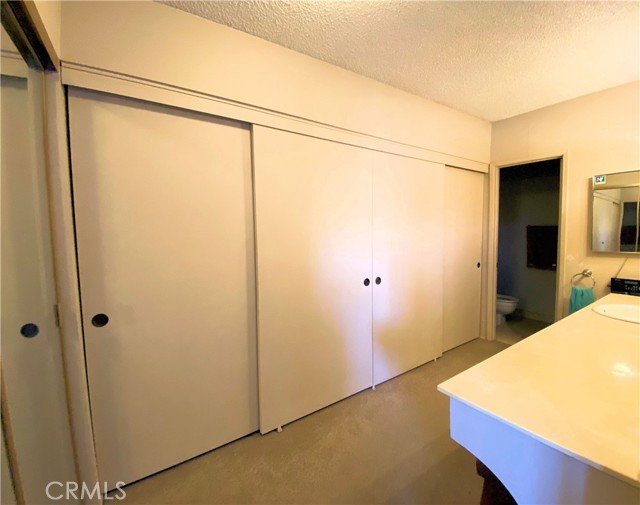 Wall to wall closets lead to the private bathroom