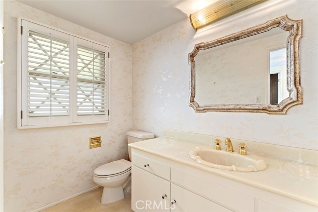 Guest half bath, plantation shutters.