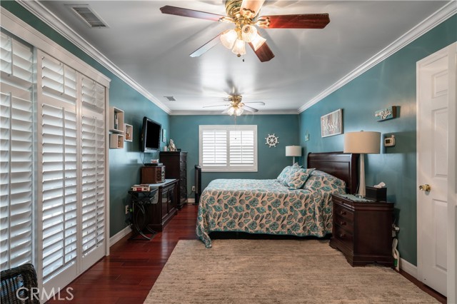 MASTER SUITE WITH DOUBLE DOORS LEADING TO COVERED PATIO