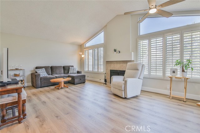 Main living room and dining area with LVP floors, vaulted ceilings, clerestory windows, lots of light