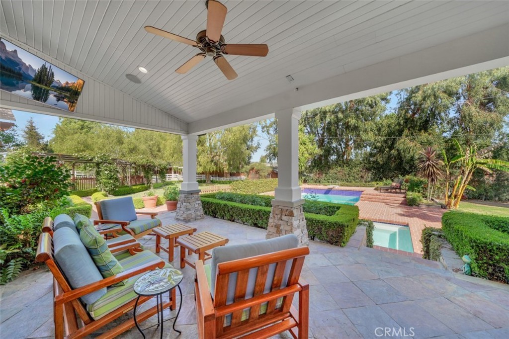 back patio overlooking the grounds, a peaceful view of the private nature of this home