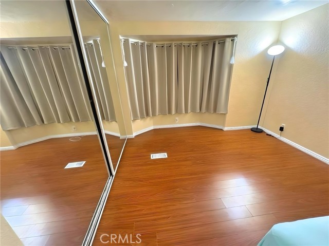2nd bedroom has laminate flooring & mirrored closet doors.