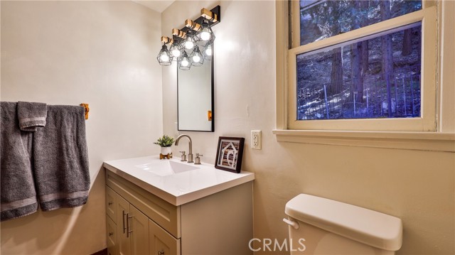 Upstairs bathroom with new vanity mirror, lights
