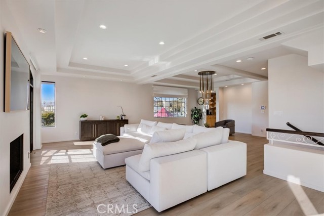 Vast living space with high coffered ceilings....with a cozy fireplace and access to a balcony on this level.