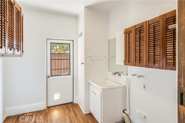 Extra large laundry room, with laundry sink, storage, and a convenient side door.