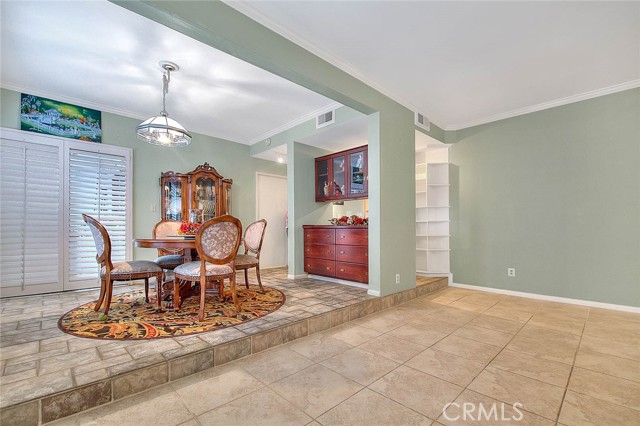 Living Room To Elegant Dining Room View. Elegant Built-in China Cabinet.  Wood Shutters Leads To Covered Outdoor Patio