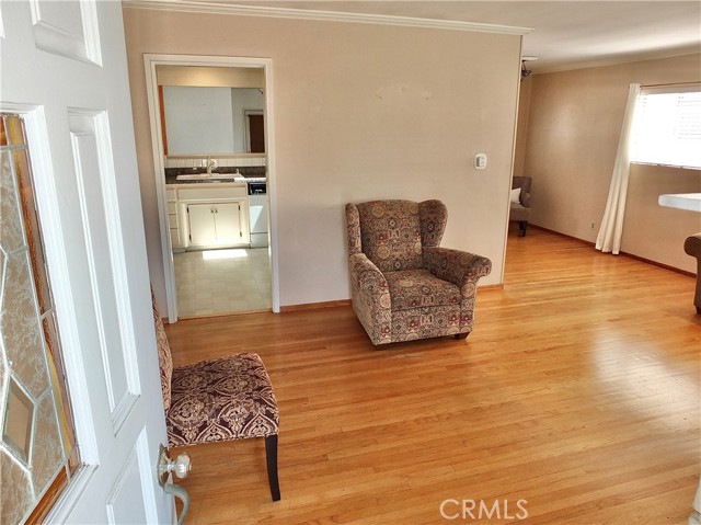 Living Room offers crown molding & original hardwood floors...