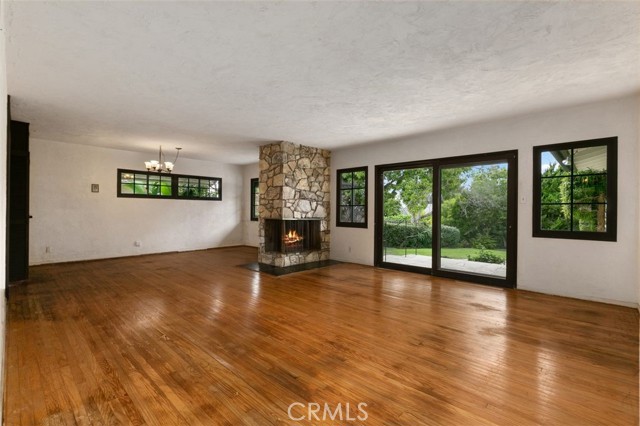 Spacious living and dining areas with wood burning fireplace.