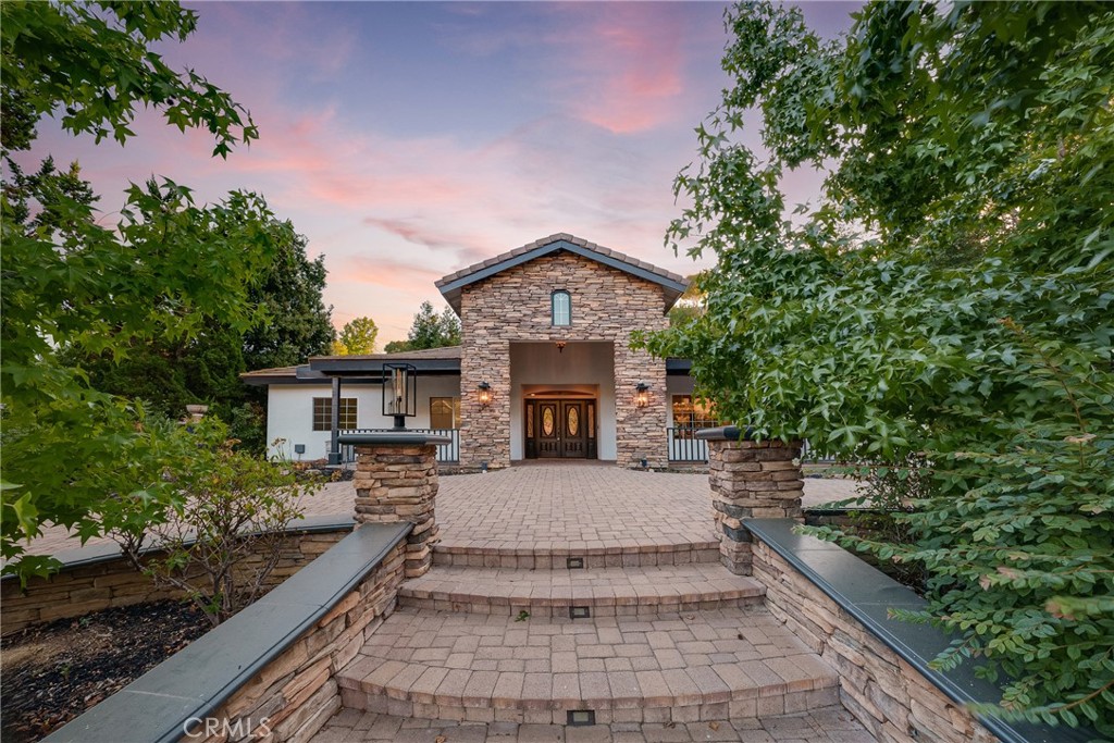 Exquisite Single Level Estate in Olinda Village with Breathtaking Canyon Views Discover the epitome of luxury living in this single-level estate, gracefully perched in the peaceful Olinda Village. Rebuilt in 2004, this home offers a blend of elegance and modern comfort, with its expansive great room that opens to breathtaking canyon views. The gourmet kitchen is a culinary dream, boasting a large island, farmhouse sink, and high-end appliances, including a double oven and warming drawer. The space extends into a grand dining area, complemented by a walk-in and butler’s pantry. The family room is perfect for cozy gatherings. The residence features a luxurious main bedroom suite with coffered ceilings, luxury wood flooring, and dual walk-in closets, leading to a backyard oasis through French doors. The ensuite bath promises a spa-like retreat with a jacuzzi tub and walk-in shower. Accompanying are four additional bedrooms with luxury wood flooring and unique bathroom amenities. Outside, the slate stone patio with an outdoor kitchen and lush garden provides a serene escape. The front porch, circular driveway, and elegant hardscaping add to the property’s allure. Set in a desirable community with top schools and no additional fees, this home is more than a residence—it’s a lifestyle.