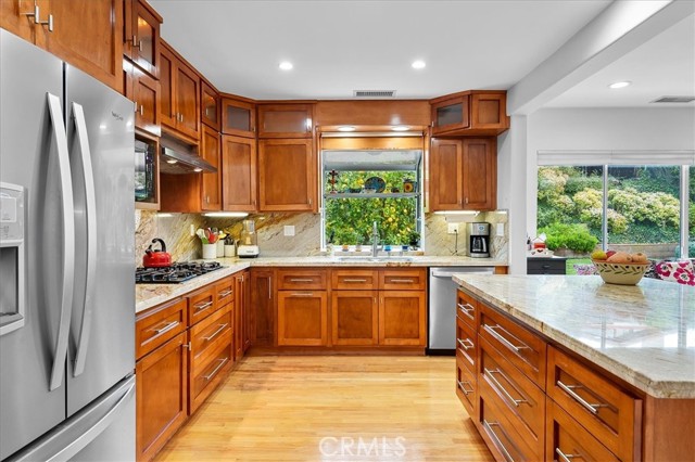 All newer stainless steel appliances and a window overlooking the beautiful backyard complete with multiple fruit trees.