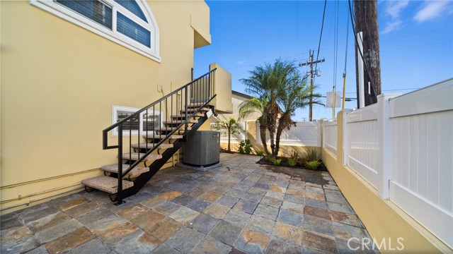 Rear Patio with stairs from family room balcony.