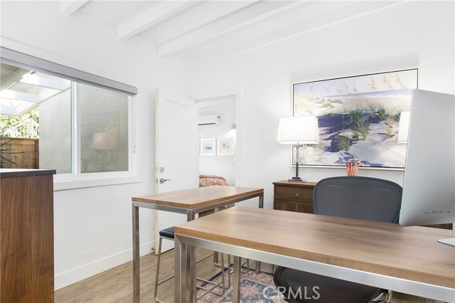 Second bedroom currently used as an office with adjoining door open to rear unit.