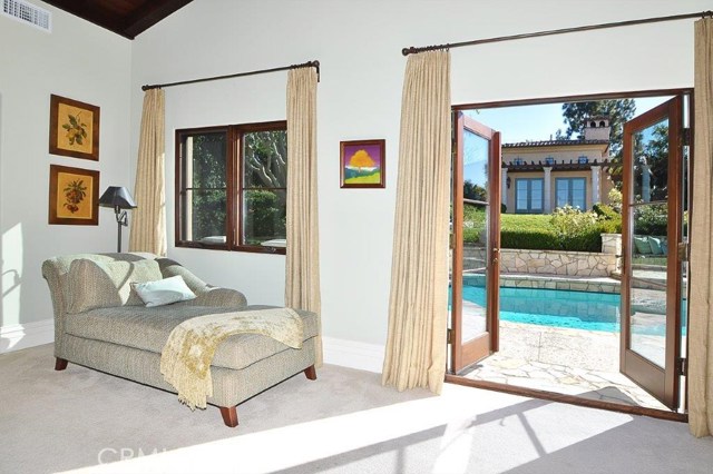 The Master Bedroom opens to the outdoor veranda and overlooks the pool and guest house