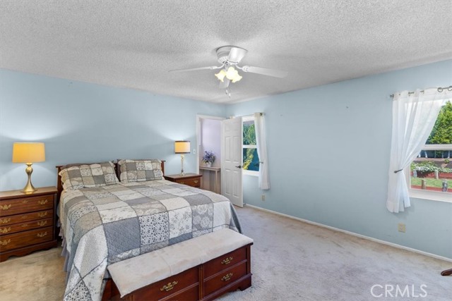 Main bedroom has views of backyard and pool.