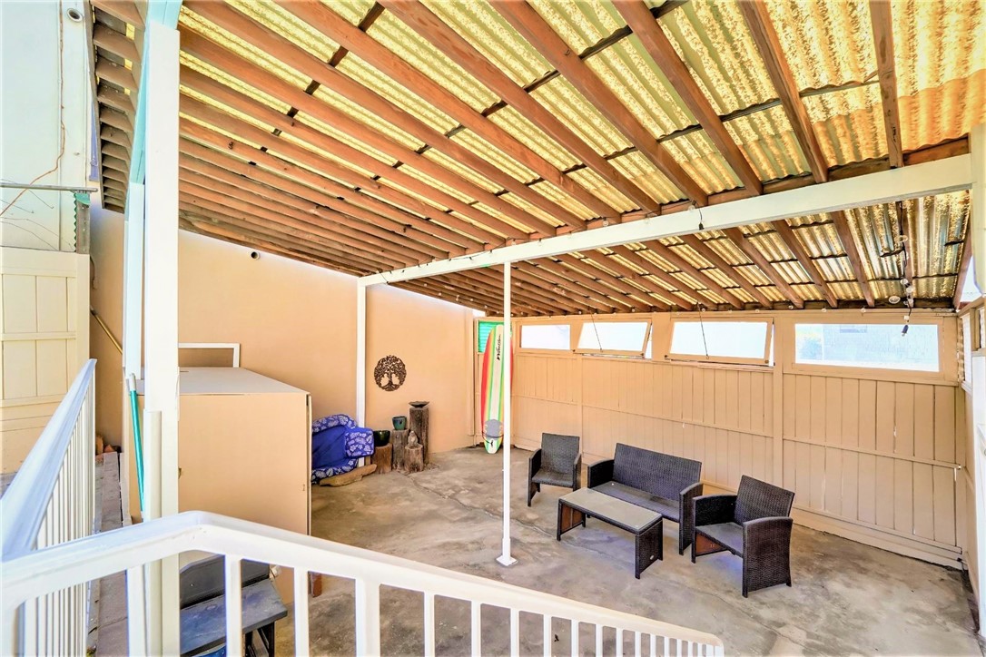 The stairway next to the pool leads down to the very large covered patio which is very private and sheltered from the wind and elements.