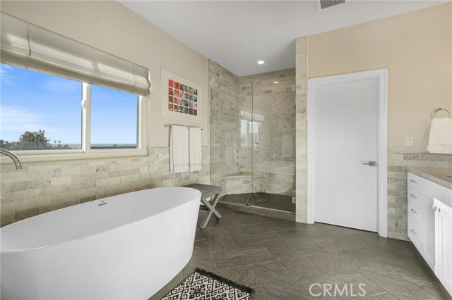 Primary Bedroom en suite with large soaking tub, walk-in shower and water closet