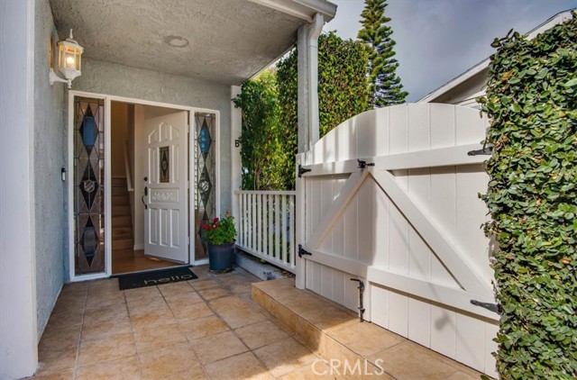 Travertine floors mark the picturesque gated courtyard entryway.