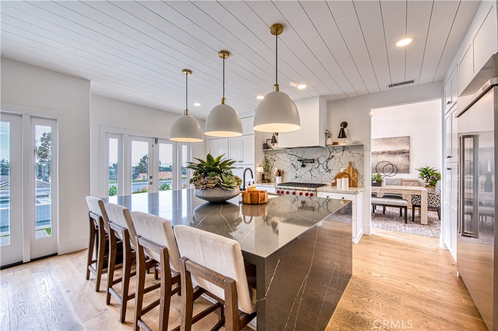 Exquisite, move-in ready OCEAN VIEW home in the prestigious 24-hour guard-gated community of Crest De Ville on a cul-de-sac with a single loaded street. This completely remodeled gem features three updated bathrooms and a modern chef’s kitchen with a Wolf range, 48” built-in refrigerator, a double-sided quartz waterfall island, and concealed appliance storage. Gorgeous wood flooring throughout, with custom tongue-and-groove accent walls and ceilings adding warmth and character. The spa-like primary bathroom boasts a soaking tub with breathtaking ocean views. The entire home has been repiped with PEX and includes new dual-zone air conditioning, smart lighting, smart thermostats, and all new doors and windows. Enjoy built-in beverage coolers on both levels, a wine fridge, and a garage outfitted with epoxy floors, custom cabinetry, overhead storage, 220V electrical access and new garage doors. The entertainer’s backyard is a dream, featuring a brand-new custom pool, spa, fire pit, built-in BBQ, refrigerator, and stunning ocean views. Community amenities include a pool, spa, basketball court, park, playground, and BBQ areas. This must-see home is just minutes from the beach, world-class resorts, and top golf courses! Home available fully furnished; furniture sold separately.