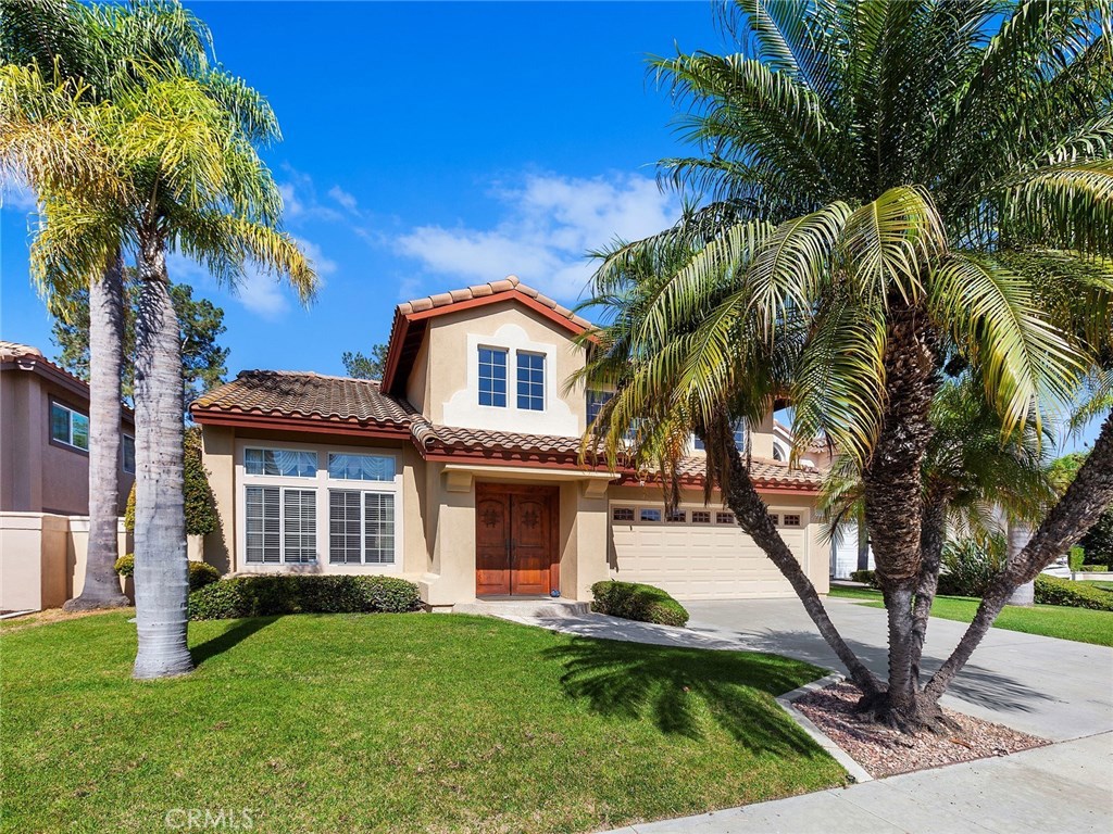 Beautifully upgraded home in the Bel Air community that has been completely remodeled.  Located on a cul de sac with a large private yard with patio and grassy lawn area. Gorgeous upgraded double door entry w/custom lighting & cathedral ceilings.  Wood floors and travertine flooring with stone accents & custom base boards throughout.  Elegant living room & separate dining room for formal entertaining.  Custom kitchen with knotty Alder cabinets with pull out drawers, decorative handles, & trim molding, granite counters, high end appliances featuring a high BTU stainless steel built-in cook top and separate built-in oven, Fisher & Packel dishwasher, built in side by side refrigerator with wood panel door. Family room features a custom gas fireplace. Downstairs bath is venetian plaster, custom lighting, vanity and sink. Upstairs master suite with vaulted ceilings, 2 closets w/mirrored closet doors & recessed lighting.  Large shower with stone tile surround, custom vanity, mirrors & lighting.  Located in a desirable location, short distance to Bathgate Elementary School.  Mission Viejo Lake membership where you can enjoy 2 beaches, boating, fishing, concerts, events and more.  Low tax rate and no mello roos.