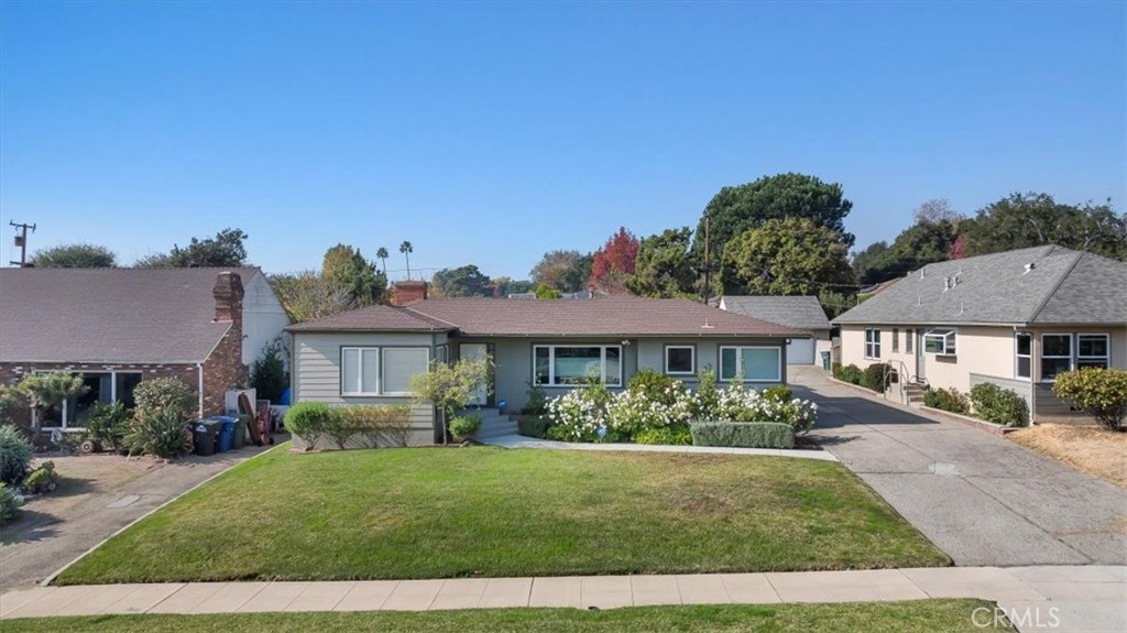 Nestled beneath the majestic San Gabriel Mountains and boasting unobstructed views of Mount Wilson, this charming property located at 1745 Grand Oaks Ave. blends timeless character with modern conveniences. Situated on a lovely, tree-lined street in a highly sought-after neighborhood north of New York Drive, this home offers a peaceful retreat just minutes from vibrant Pasadena. Step inside to discover an open and light-filled floor plan with beautiful hardwood floors, updated finishes, and thoughtful design details throughout. The inviting living room, complete with a cozy fireplace, flows seamlessly into the dining area and kitchen, making it perfect for entertaining. The kitchen boasts stainless steel appliances, quartz countertops, and ample storage, while large windows frame the beautiful mountain views. There are three comfortable bedrooms, including the primary suite featuring an upgraded en-suite bathroom and an additional hallway bathroom, which has also been updated more recently. Located off of the enclosed porch, you’ll find two separate and spacious backyard areas with room to expand. This property features a detached garage, offering the potential for a workshop, studio, or ADU conversion. Located near Altadena’s hiking trails, parks, and local shops, this home truly has it all.